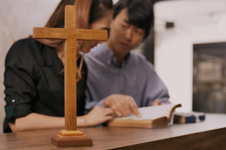 Young missionary is giving Bible advice to young woman in church.